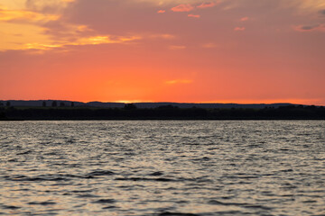 beautiful bright sunset on the lake in the summer