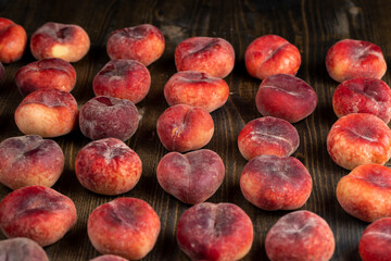 a pile of ripe washed peaches on the table