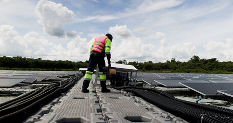 Naklejka premium An African-American engineer carefully examines a cutting-edge floating solar panel system designed to harness renewable energy for an industrial complex.