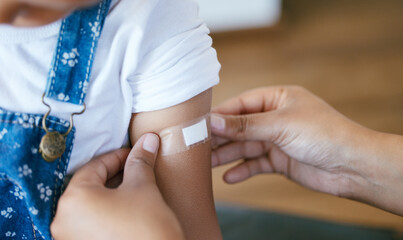 Hands, pediatrician and arm of child with plaster for immunization shot, medication or injection. Healthcare, consultation and doctor with kid for medical vaccine treatment with patient in clinic.