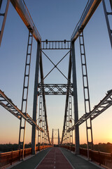 Bridge at dawn. Bridge with bicycle line and pedestrian walkway. Perspective
