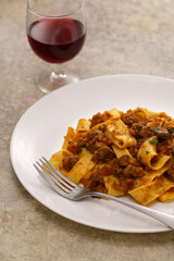 Homemade pappardelle pasta with lamb ragu sauce. Italian cuisine.