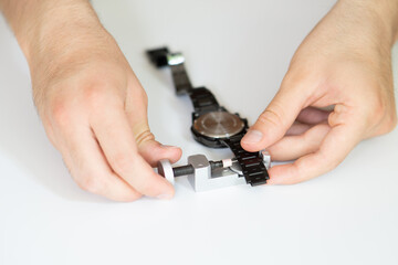 Adjusting watch strap with link remover tool