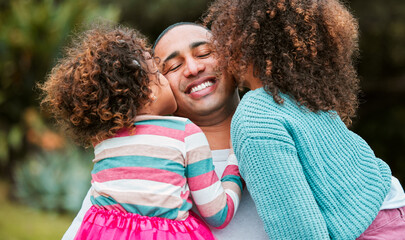 Father, girl children and kiss in park with hug, care or connection with love, smile or outdoor in nature. Man, dad and kids with embrace on vacation, spring and garden for happy family in Colombia