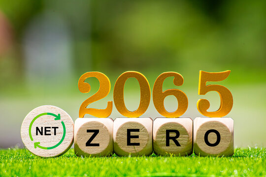 Carbon Credit Market. Carbon credit icon in hand on green leaf background. Icon energy and environmental protection round green energy neutral carbon Net zero greenhouse gas emissions target in 2065