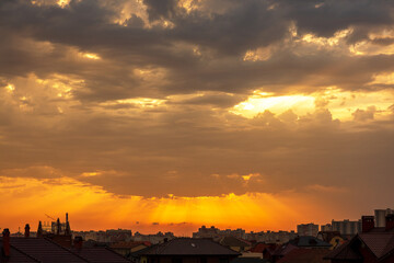 Sunset over city. Evening city landscape. Sunset over multi-story buildings. Cityline with colorful sky. Residential area of the city in evening. Cityscape with summer sunset. Town, metropolis