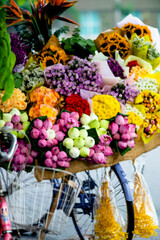 creates a big picure mix in green and pink. 
Everything standing in traditional clothing.
fences surrounded by pink wildflowers