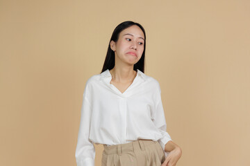 Fototapeta premium Disappointed Woman with Pursed Lips, Beige Background