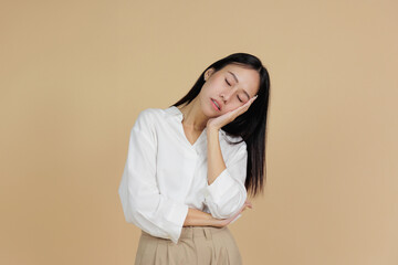 Sleepy Asian Woman Resting Head on Hand with Tired Expression