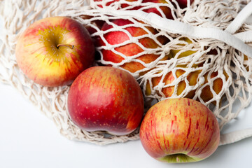 Bag of s with reds and greens on it's mesh. eco reusable food concept. a bag of fruit with s and pears in white on a . a bag of fruit with a red and white and lifestyle wicker.