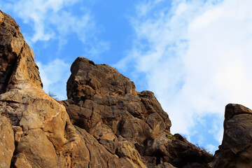 Fototapeta premium Rocks stones in nature against a blue sky. sunrise nepal morning concept. rocks and yellow and blue sky in nature. rocks and stones in nature in yellow and blue with a blue lifestyle sky.
