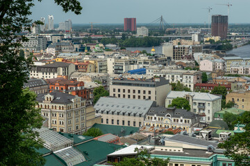 View of the Podil and Obolon districts from Saint Volodymyr Hill Park. Various old historical and new buildings in the oldest area of Kyiv, Ukraine.