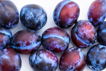 Obraz premium White and plum fruit on a white. Vegetable prune blue concept. A of plums and other fruits in purple and white. A of white and purple fruit with plums lifestyle.