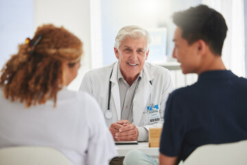 Obraz premium Mature doctor, couple and smile for results, good news and medical clinic info for IVF treatment wellness. Gynecologist, discussion and people happy for feedback report, notes or health communication