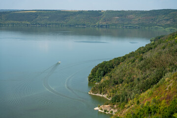 Unique nature of Dniester River and Bakota Bay. 
Late summer or early autumn boat tour travel along the high banks on the slopes of beautiful Khmelnytskyi region in Ukraine.