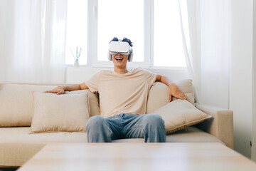 Virtual reality experience, technology, relaxation, modern interior, smiling person immersed in digital world sitting on a cozy sofa, white curtains, bright ambiance, joyful mood