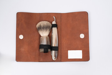 a luxury beard shaving kit lies in a leather case on a white background
