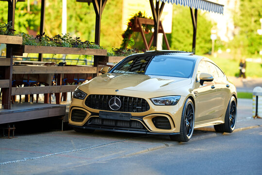 Minsk, Belarus. May 7, 2024. Parked Mercedes-AMG CLA 45 S Coupe near restaurant street terrace, sleek design and premium feel of luxury vehicle. Parked Mercedes AMG CLA sport coupe, street view
