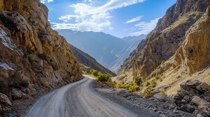 A breathtaking view of a mountain road with dramatic rock formations on either side, capturing the rugged beauty and challenging terrain of the route.