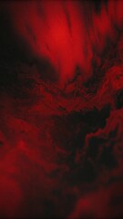 A dark, abstract image showcases irregular patches of deep red and black, blending together in a fluid, organic manner.