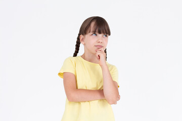 Cute girl thinking about smth. Young brunette girl is thoughtful on white background