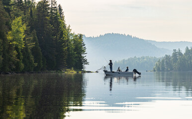 Early morning fishing boat on a lake