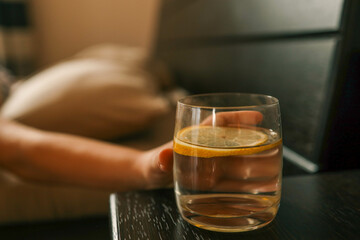 Close up of woman's hand taking a glass of water
