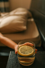 Close up of woman's hand taking a glass of water