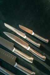 Casting steel various chef knife, Set of modern sharp kitchen knives on dark background