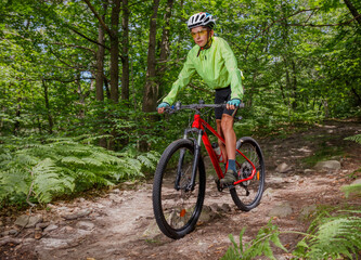 Biking adventure in a dense, beautiful forest on rugged trail