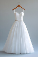Fototapeta premium White wedding dress isolated on light grey background