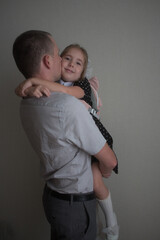 Dad holds first grader in his arms