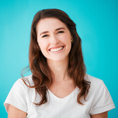 Portrait, smile and woman in studio for hair care, beauty or texture isolated on blue background. Face, happy hairdresser and professional stylist at salon for natural hairstyle or growth in Ireland