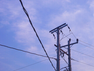 Power electric pole with line wire for residential buildings with blue sky background