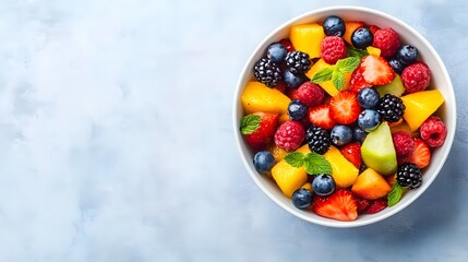 A vibrant bowl of fresh fruits including berries, melon, and pineapple, perfect for a healthy snack or dessert.