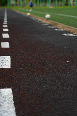 Fototapeta premium A blustery line on the rubber track of the school stadium