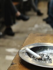 cigarette in ashtray, metal, iron, or steel ashtray, white filter smoke or cigarette, smoking danger, healthcare and medical