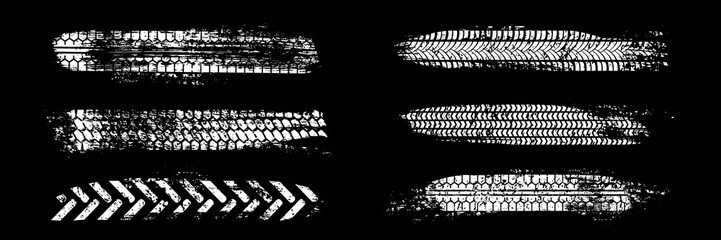 Tire tracks. Car, bike, motorcycle tyre marks with grunge effect set isolated on black background. Collection of different wheels footprints on the road. Top view of rubber protector marks. © backup16