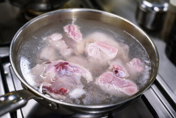 Preparing Traditional Korean Dish Andong Jjimdak: Chopped Chicken Boiling in Stainless Steel Pot