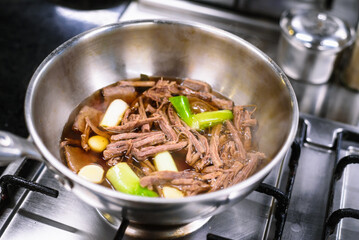 Preparing Soy-Braised Quail Eggs and Shredded Beef in a Stainless Steel Potg
