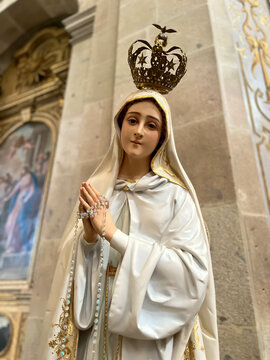 Image of Our Lady of F&aacute;tima with Crown and hands folded in prayer in the Basilica of Santuario do Sameiro in Bom Jesus do Monte, Braga, Portugal.