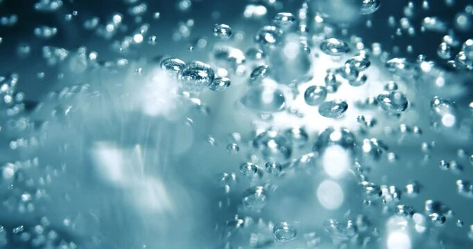 Many water bubbles in blue water close up, abstract water wave with bubbles in slow motion.