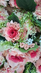 Silk flowers various color flower background wall with pink fabric.