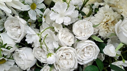 Fototapeta premium Silk flowers various color flower background wall with white fabric.