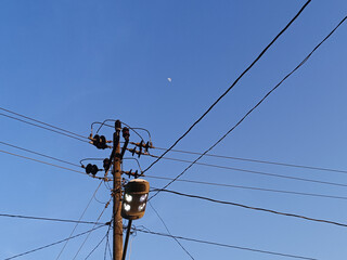 Power electric pole with line wire for residential buildings with blue sky background