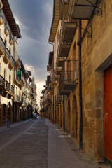 Puente de La Reina, Navarra.  The tower of the church of Santiago el Mayor rises, immense, over the roofs of the town