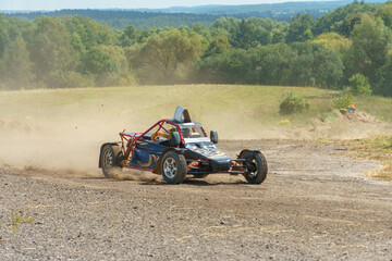 Fototapeta premium Autocross on a dirt track. rally race. Off-road racing. Training races of racing drivers. Modern modified cars on the road.
