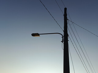 Power electric pole with line wire for residential buildings with blue sky background