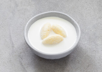 Children Milk soup with sweet cottage cheese quenelles. Close up