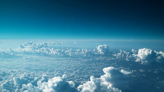 Majestic aerial view of a deep blue sky with towering cumulus clouds.

